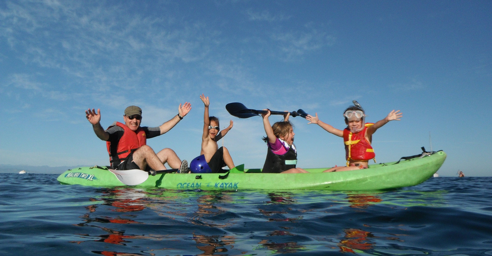 kids and an adult in a kayak