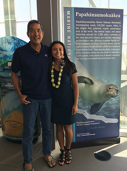 Kammie Dominique Tavares and another person standing next to a papahanaumokuakea rollout poster
