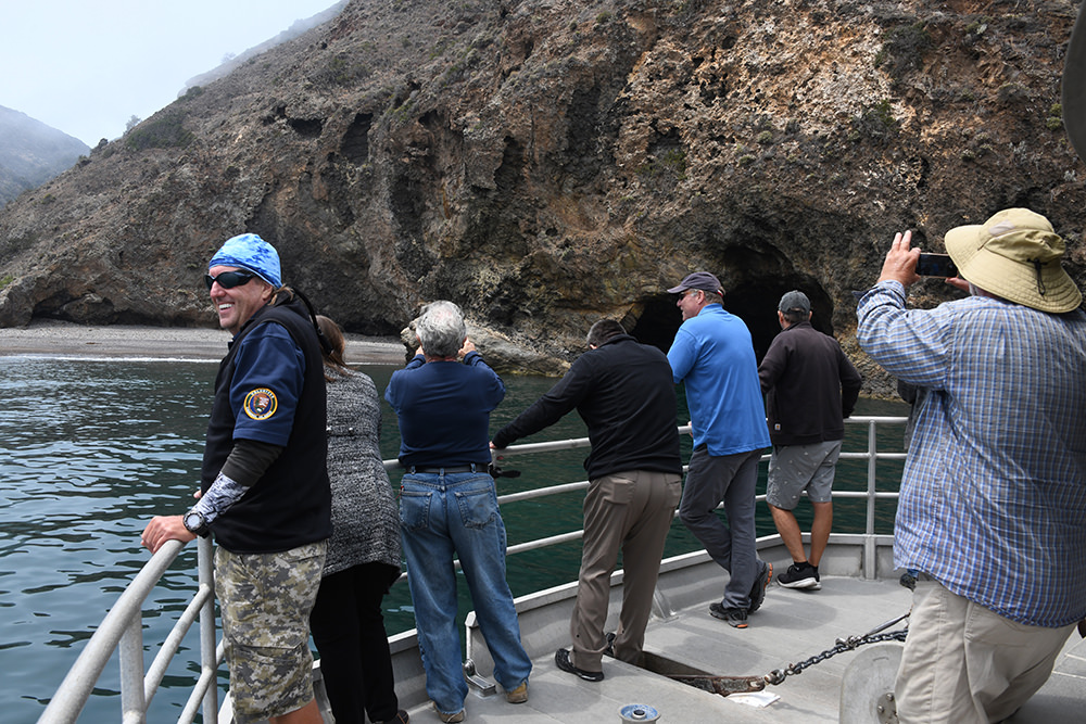 people on a boat looking at sea caves