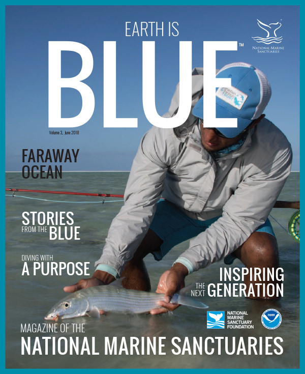 earth is blue magazine volume 3 cover - angler holding a fish