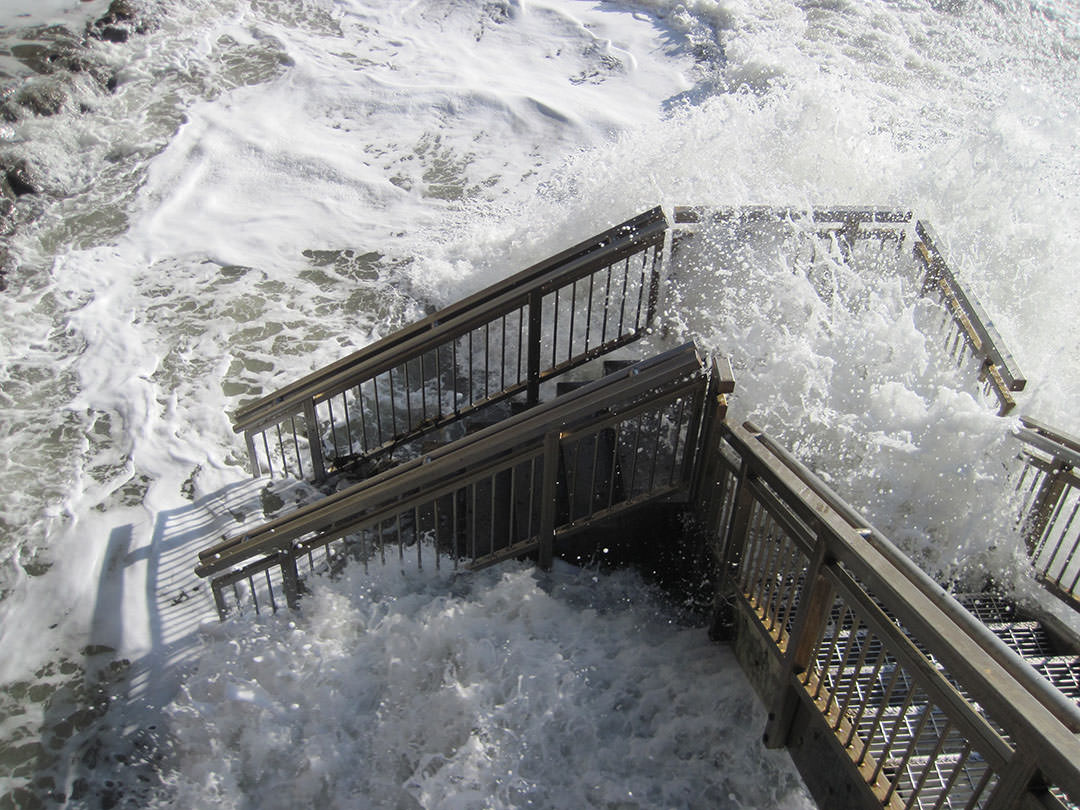 An especially high tide off Santa Barbara, California inundates a stairway to the beach.
