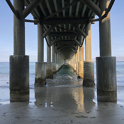 underside of a pier stretching into the ocean