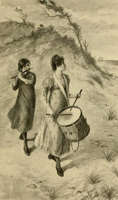 two young women in colonial dress play a fife and a drum while walking along a sand dune