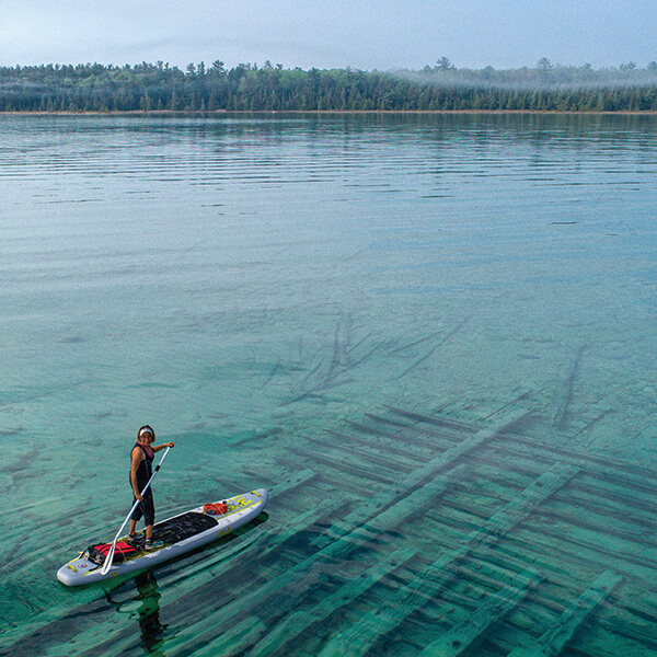 A stand up paddle boarder in Thunder Bay National Marine Sanctuary