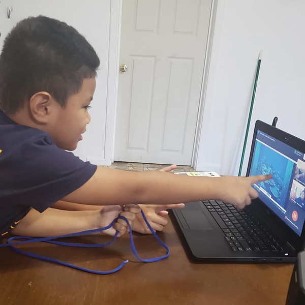 kid pointing at a computer screen