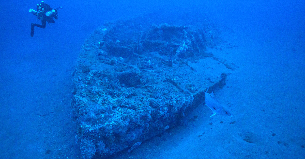 Diver looking at the wreck of the Monitor